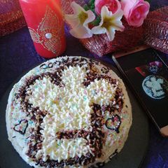 A picture of Chocolate cake with chef's hat.