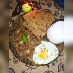 A picture of Qeema Do pyaza with crispy Paratha and Strawberry Lassi.