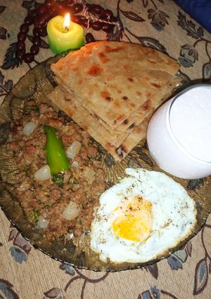A picture of Qeema Do pyaza with crispy Paratha and Strawberry Lassi.