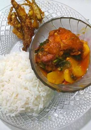 A picture of Fish Potato Curry and Rice with Fried Prawns.