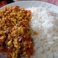 A picture of Scrambled eggs and tomatoes.