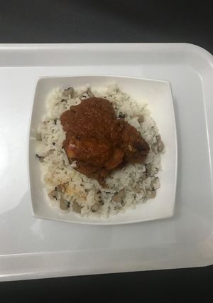 A picture of Chicken Stew Served with Rice and Bean.