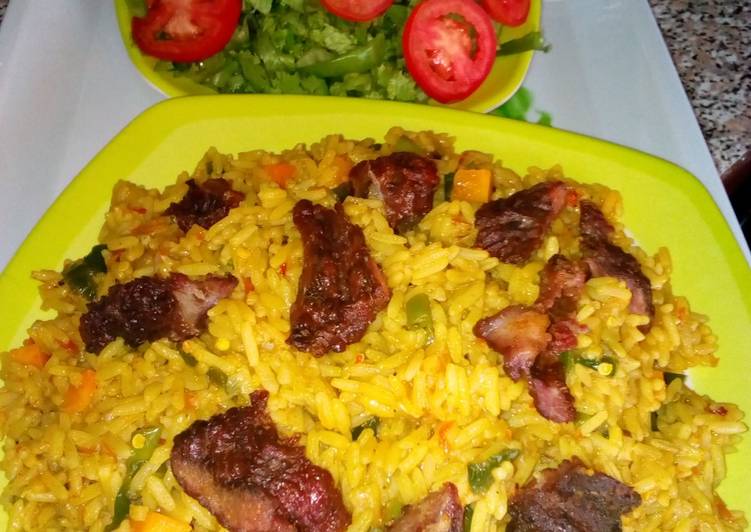 Recipe of Delicious Jollof rice with roasted meat and salad