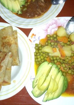 A picture of Chapati and peas stew with fried meat plus ovacado.