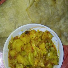 A picture of Gurasar larabawa with potatoes and cabbage sauce.