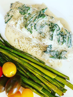 A picture of Salmon with Blue Cheese and Spinach Sauce.