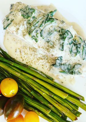 A picture of Salmon with Blue Cheese and Spinach Sauce.