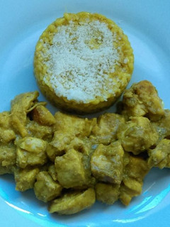 Una foto de Pechuga de pollo en crema de coco y risotto de curry con parmesano