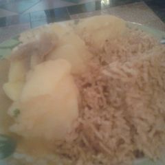 A picture of Pilau served with boiled potatoes.