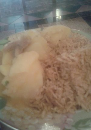 A picture of Pilau served with boiled potatoes.