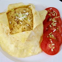 A picture of Onion turmeric pulao wrapped in egg.