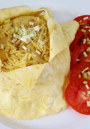 A picture of Onion turmeric pulao wrapped in egg.