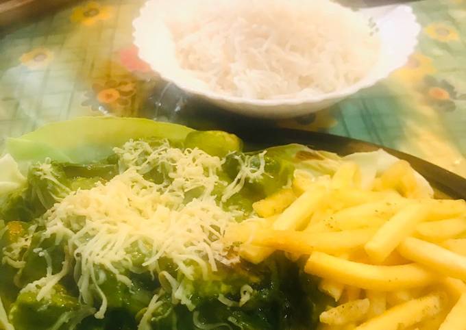 Pesto sauce boiled veggies with French fries and steamed rice in a sizzling plate