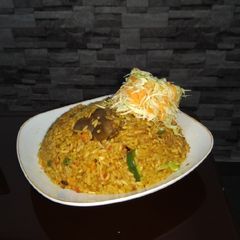 Jollof rice and fresh veggie A picture of Jollof rice and fresh veggie.