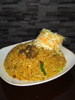 A picture of Jollof rice and fresh veggie.