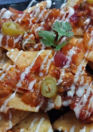 A picture of Cornitos with tomato salsa and cheese sauce.