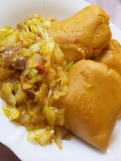A picture of Moi moi and cabbage sauce.