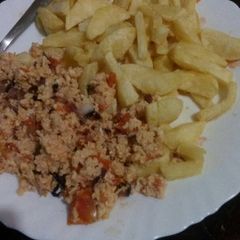 A picture of French fries with scrambled egg.