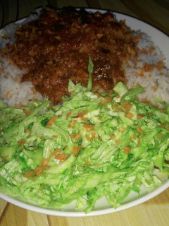 A picture of White rice and stew with simple colour salad.