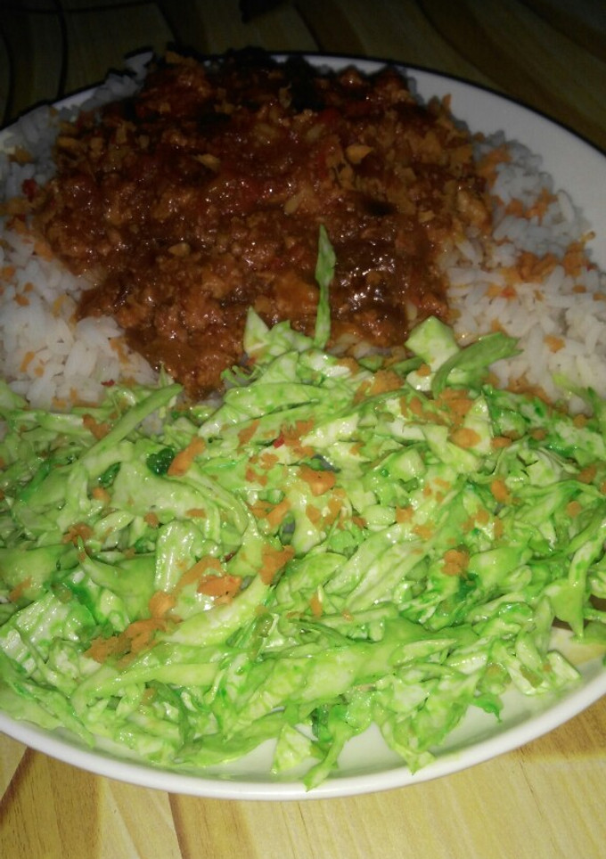 A picture of White rice and stew with simple colour salad.