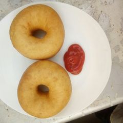 A picture of Almond doughnuts served with ketchup.