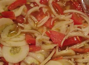 A picture of Tomato, cucumber and onion salad.