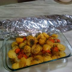 A picture of Roasted fish and roast potatoes.