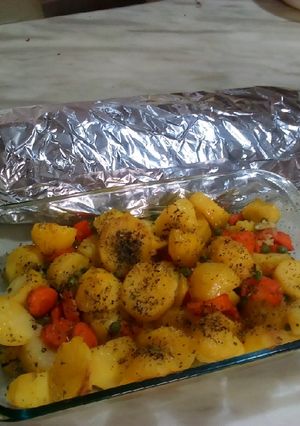 A picture of Roasted fish and roast potatoes.