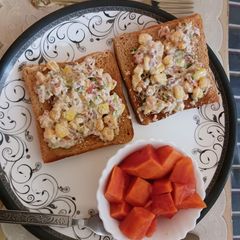 A picture of Bread sandwich and ripe papaya.
