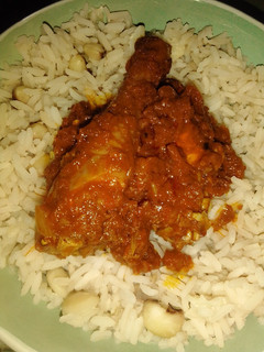 A picture of Rice and beans with chicken stew.