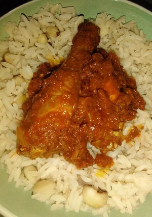 A picture of Rice and beans with chicken stew.
