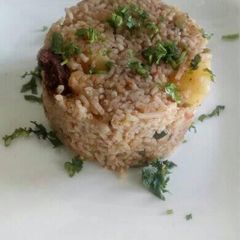 A picture of Goat pilau with potatoes and coconut.