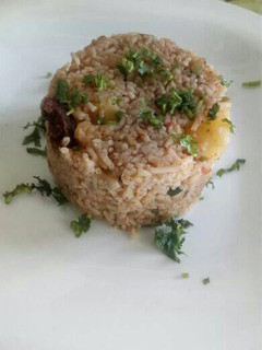 A picture of Goat pilau with potatoes and coconut.