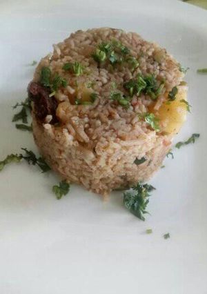 A picture of Goat pilau with potatoes and coconut.