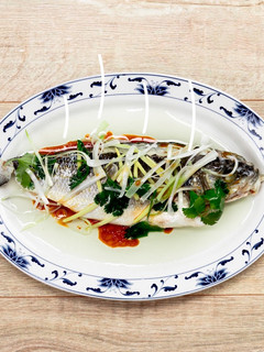 A picture of Steamed white fish with ginger, spring onion and soy sauce.