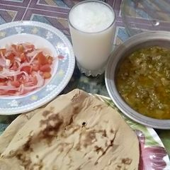 A picture of Ghia Tori ki sabzi with salad,lassi and tandoor ki roti.