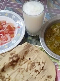 A picture of Ghia Tori ki sabzi with salad,lassi and tandoor ki roti.