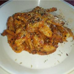 A picture of Potato Wedges in Cajun and Pasta sauce.