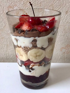 Una foto de Postre con yogurt, chips de chocolate,frutillas y banana