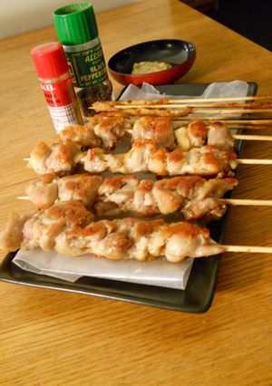 A picture of Crispy Salt-Grilled Chicken Skewers in a Skillet.