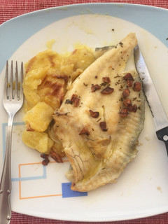 Una foto de Lomo de rodaballo al horno con patatas panadera y refrito de ajos