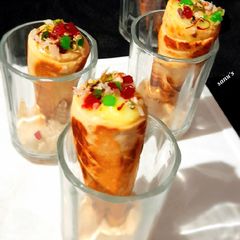 A picture of Kesar Pista Custard In Homemade Ice cream Cones.