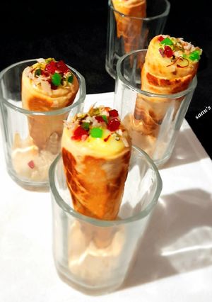 A picture of Kesar Pista Custard In Homemade Ice cream Cones.
