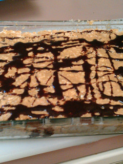 A picture of marshmellow Krispy with peanut butter & chocolate drizzle.