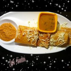 A picture of Masala Dosa with sambhar.