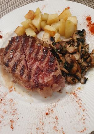 A picture of Ribeye Steak with Provençal Mushrooms and Red Potatoes.