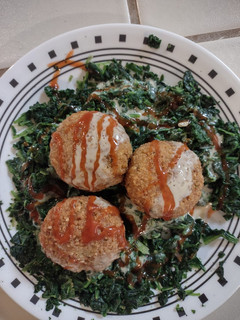 A picture of Falafel & steamed spinach.
