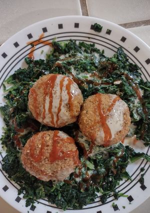 A picture of Falafel & steamed spinach.