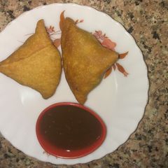 A picture of Peas samosa with date chutney.