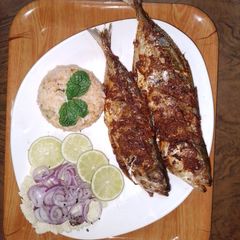 A picture of African- indo grilled fish with tomato rice and onion salad 🍅🐟.